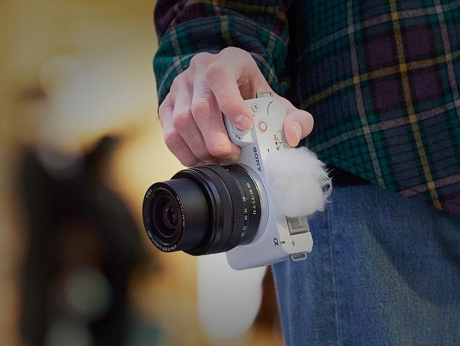 Close up of a person holding a Sony camera